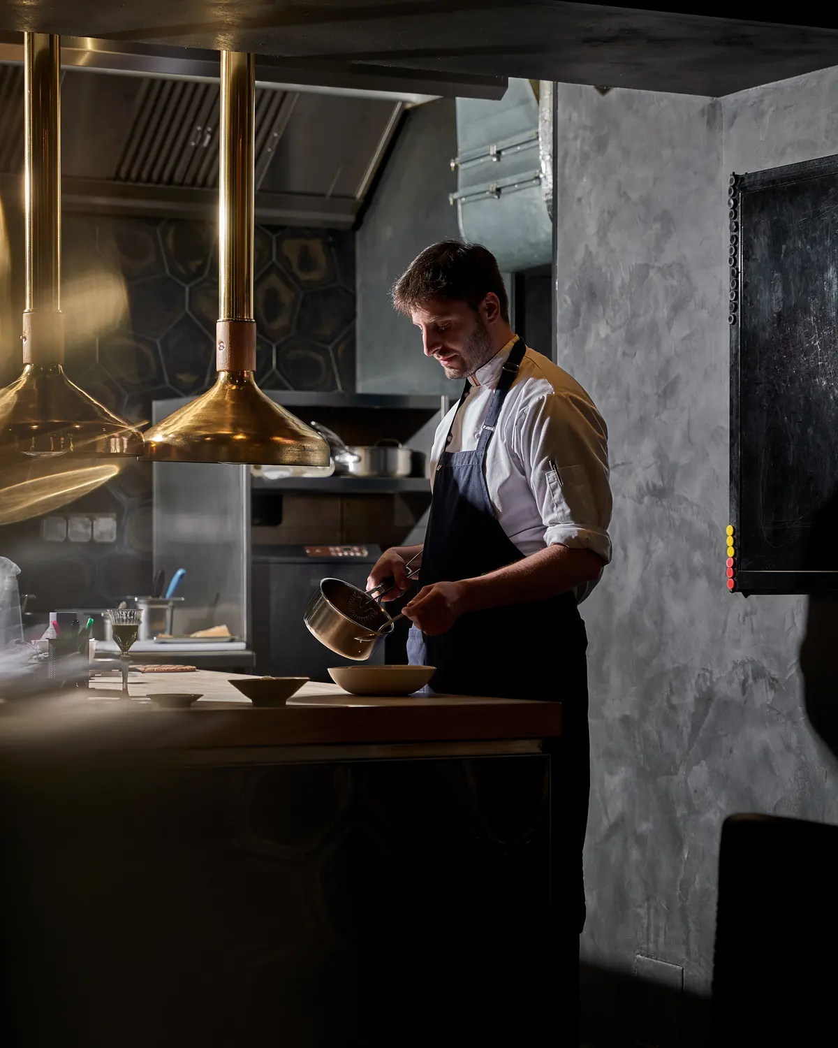 Chef preparing a dish in the restaurant’s open kitchen.